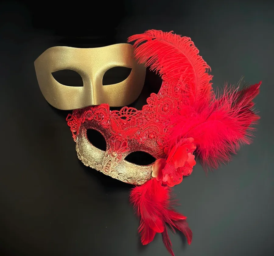 Red and gold Venetian masquerade masks with lace and feathers